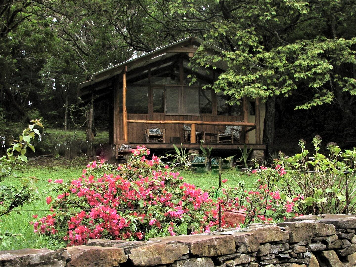 Bunkhouse from garden with stone wall